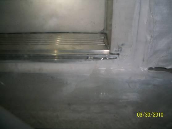 (See Photograph #8) Upon further inspection, a void in the sealant was noted at the exterior bore plate; sealant was applied and retested.