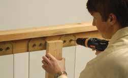 The distance from the front edge of the stair tread to the top of the rail is typically 36". Use a baluster as a guide to determine placement of the bottom rail.
