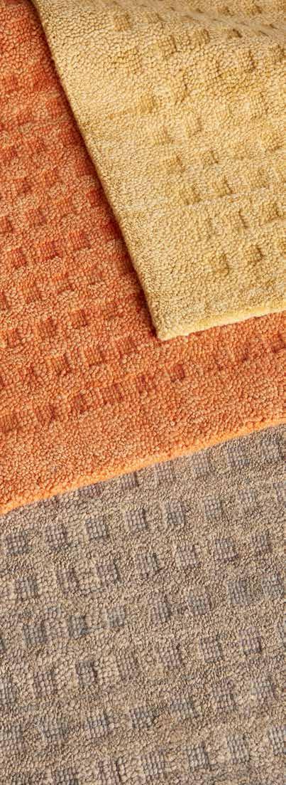 The handloom woven shadowbox design lends added dimension to each rug s luminous solid shades of blue, orange, green, yellow, and brown.