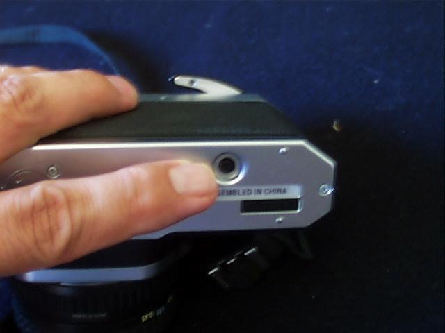 Make sure the teeth are properly placed in the holes on the film on BOTH sides of the film. Next use the rewind knob to take up the slack - to tighten the film in the camera.
