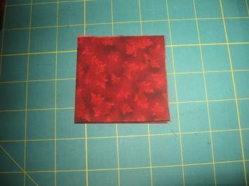 Step 1: Fold background piece in half, press, fold in half again,