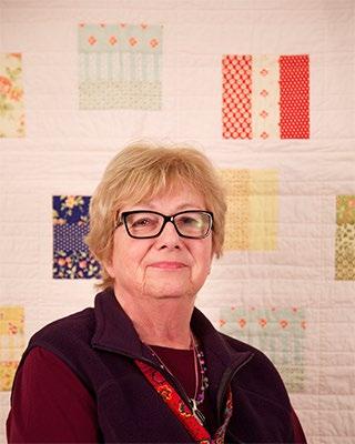 She chose her background quilt because she s partial to greens and loves to paper piece. RoseAnn B.