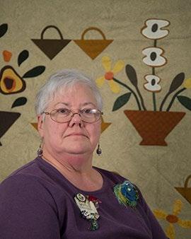 Her background quilt was chosen because it is an appliqué pictorial of a