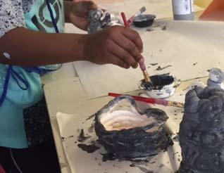 Students then glazed their clay pieces to complete the