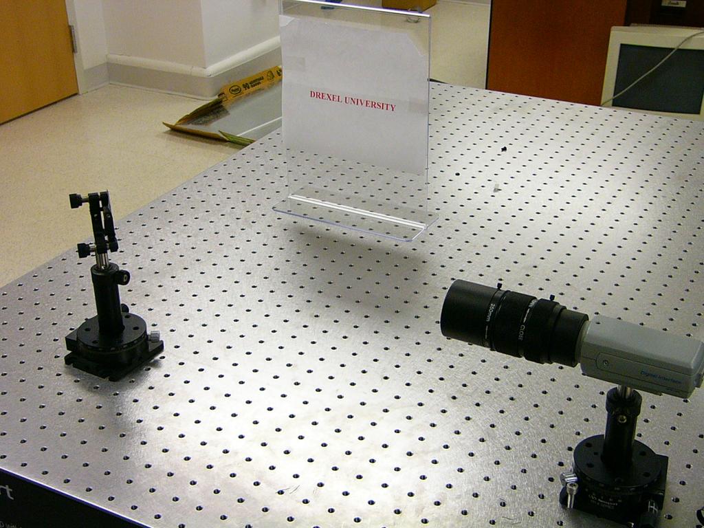 Figure 6. The experimental set up of our system design. The camera, the mirror and the object plane form a right angle. The mirror is sitting on a rotational stage to scan the image. 4.