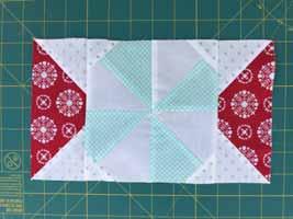 Sew along the diagonal line. Trim 1/4" away from the line, and press out. Discard cut away triangles.