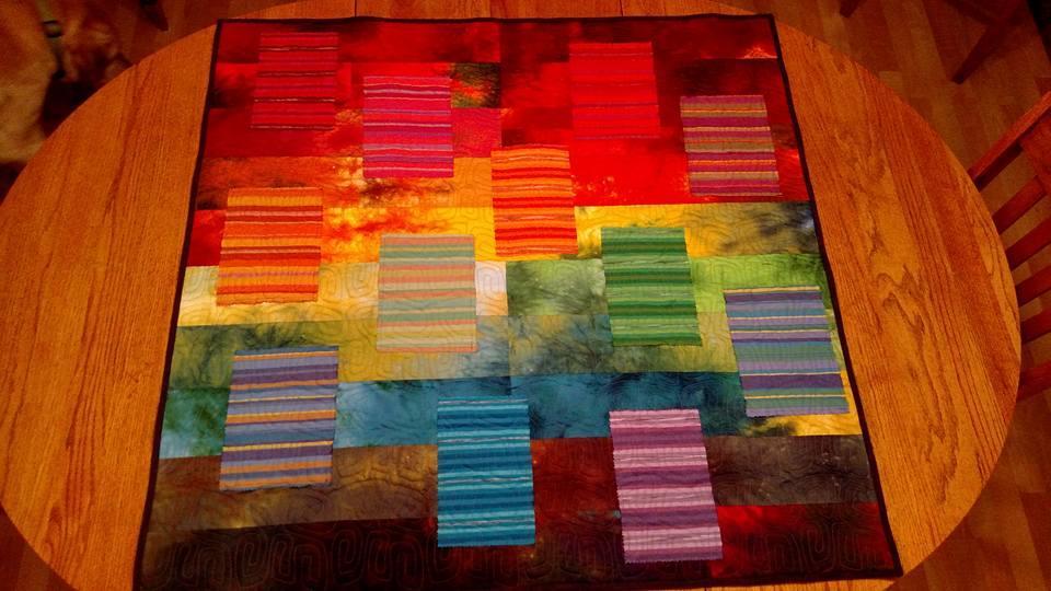 LARGE quilts (greater than 45 wide) will need a sleeve on the back top edge. Cut a strip of fabric the width of the quilt top and 10 wide. Fold in half lengthwise and sew a ¼ seam.