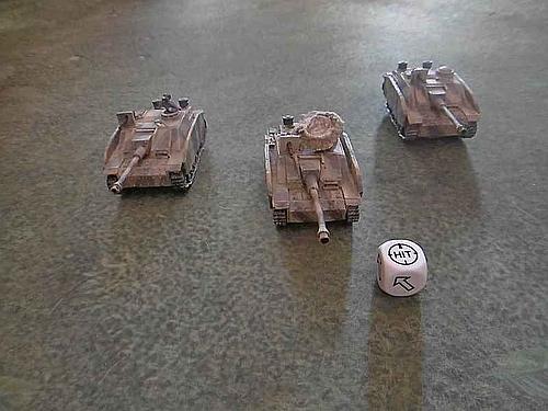 A hit is rolled - the targetted StuG III is hit along with the other two StuGs. If an arrow is rolled the fire deviates in the direction of the arrow.