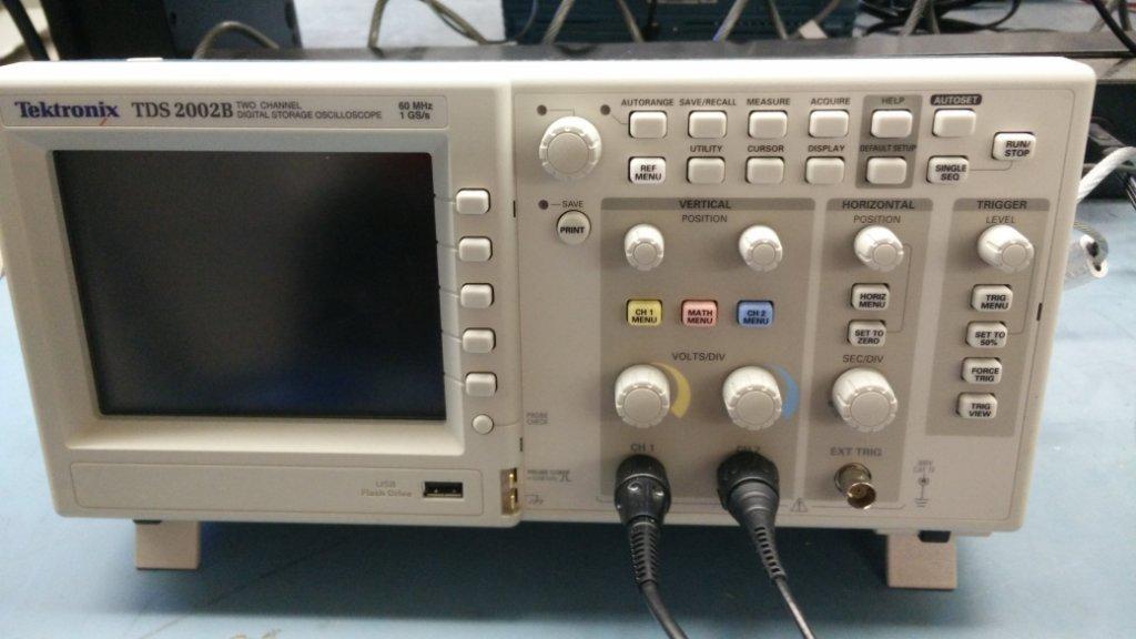Set the function generator to output a sine wave at about 100 Hz. Now, to see the sine wave on the oscilloscope, you need to make sure the oscilloscope is displaying the correct range of voltages.