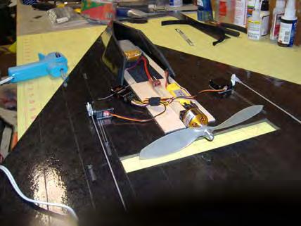 Hot glue forward fuselage into notches in wing.