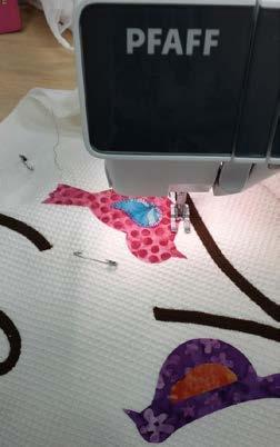 Using a variegated thread, blanket stitch around the outside of the birds