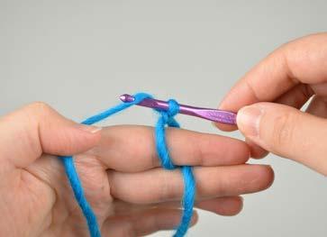 Hold onto the cut end of the yarn with your thumb.