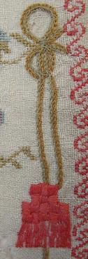 freehand-stitched flower at the right end of the