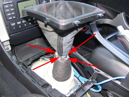 Step 7: Using a flathead screwdriver, carefully pry the clips away from the to unhook the boot from the shaft,