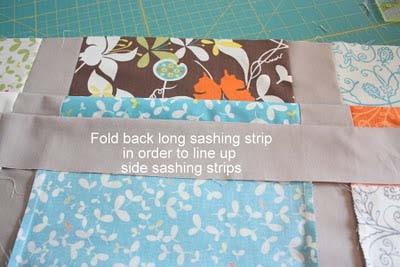 5. In order to make sure the side-sashing strips match up, place the row with the long-sashing strip sewn to it on
