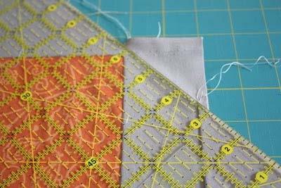 Fold back the row with the solid sashing strip at the top and make sure the side sashing segments are lined up.