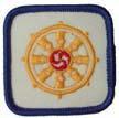 Square; white, cotton: Dharma Wheel in yellow stitching with red symbol in centre; edge binding in yellow stitching. - Buddhist Faith - Stage 2 1. R1032 2. POR (1997) 3.