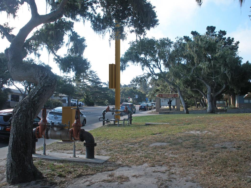 ATTACHMENT G - Rendering Design Option B Yellow Pencil Pacific Grove HS SC1 ROW in front of 615 Sunset Drive Pacific Grove CA 93950 View 4 proposed pole with antenna and pole mounted equipment