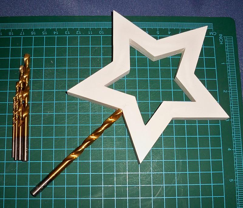 Cut out their centres and remove a strip of card as wide as your handle from the foamboard at the bottom of each star on the inside (the two surfaced which will be glued together).
