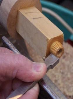 the tenon that will be threaded. Threading the tenon on the top of the base section.