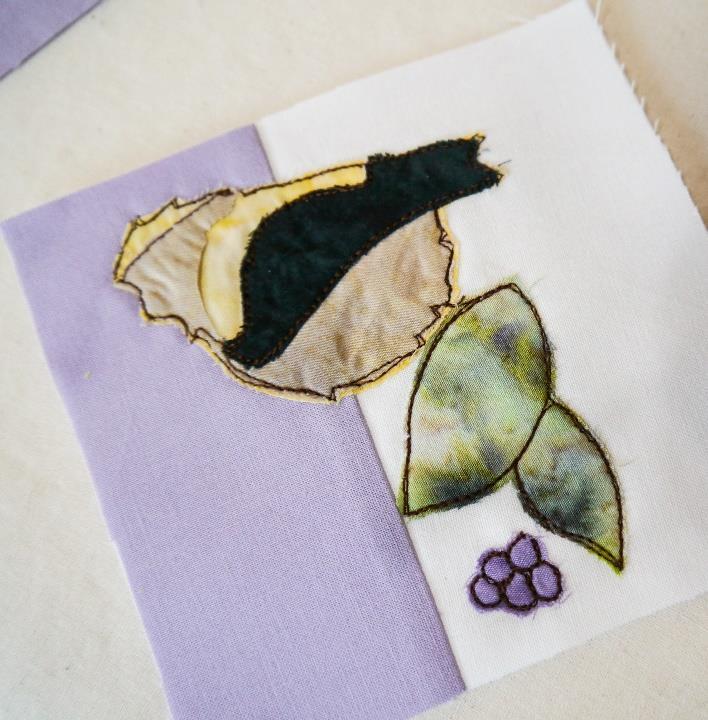 Cut the main leaves out of the darker green fabric all as one piece. We can separate the leaves with embroidery later. Cut the little stem to the flower head out of the light green.