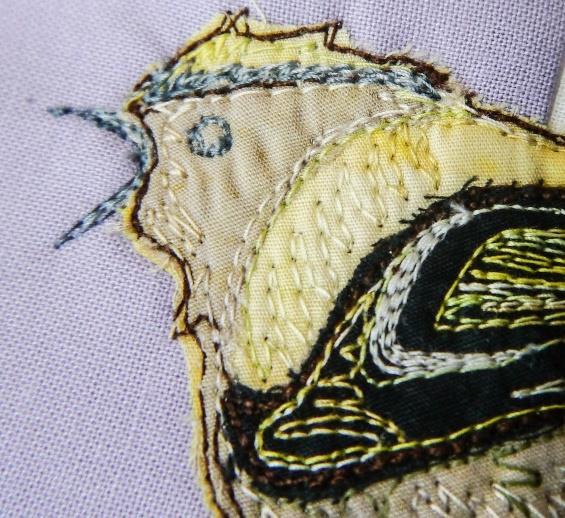 You can use this thread to catch down the raw edge of the remaining beige fabric. Change to a variegated green (TU32) and add in the leave veins.