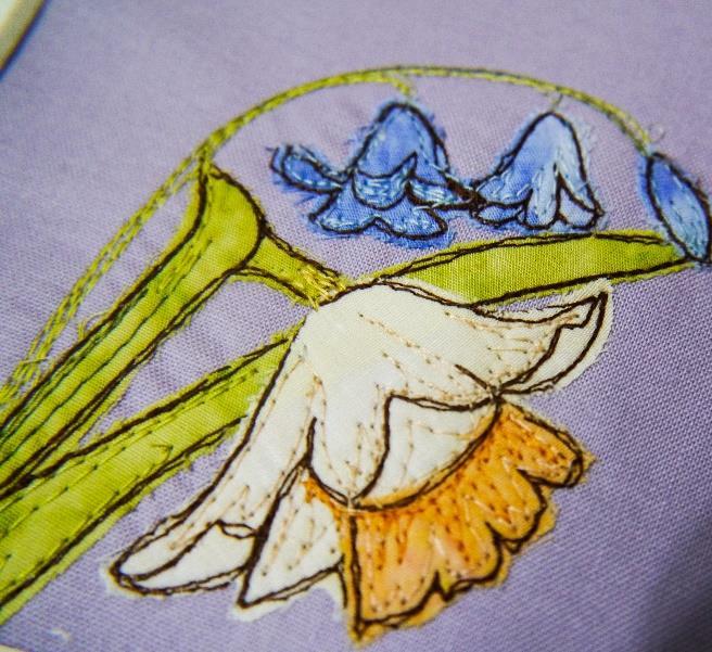 (TU32) Position the embroidery against your mount and determine where you want the daffodil stems to
