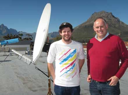 Juan-Pierre Jansen van Rensburg (MSc,completed 2012) and David Davidson with the one dish of two-element Stellenbosch University Experimental Interferometer in the background.