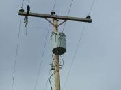 If electricity companies transmitted electricity at 240 volts through overhead power lines there would be too much