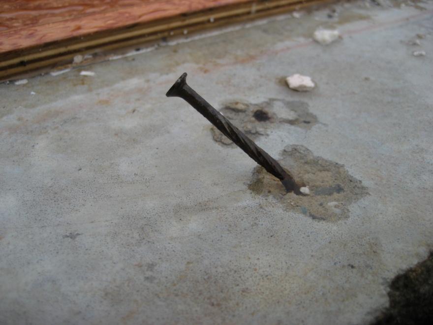 Figure 3 Failed Nail Connection of Wall Bottom-Plate to Slab.