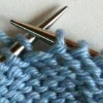 Step 3: Return the slipped stitch to the left needle. Step 4: Turn your work.