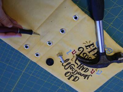 Cut the holes, and set all eight grommets or eyelets on the cover.