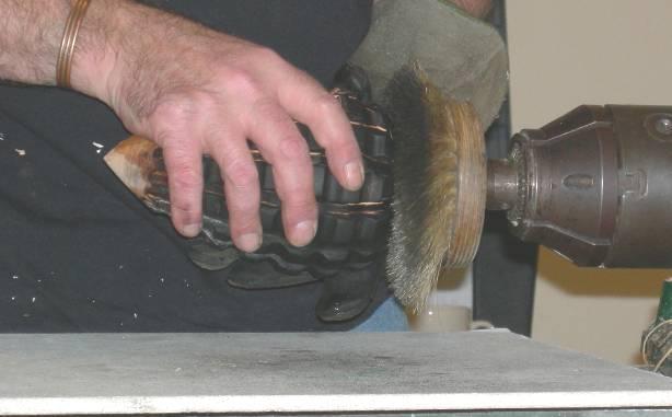The easiest way to support it for this exercise is to have a tapered piece of wood in the chuck and inserted into the neck of the hollow form.
