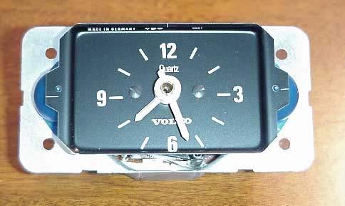 Using the small flat blade screwdriver, remove the two small screws holding the faceplate to the tachometer.