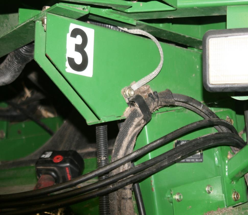 Pull hydraulic hoses up through feeder house pivot casting. See Figure 3.