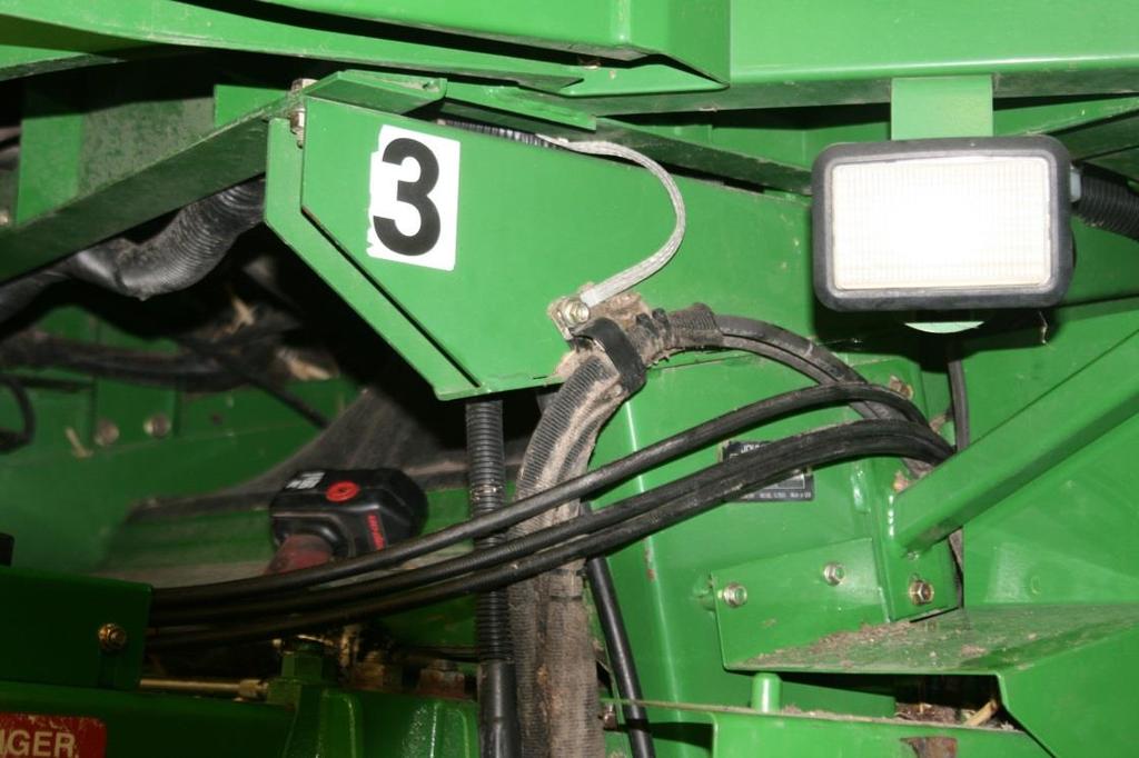 Refer to Figure(s) 3.12 Note: Old reel drive hose and return to filter hose routed behind cab to right side of combine will not be used and will need to be removed. 3.14 Route new reel drive pressure hose (Yellow) and reel drive return hose (Red) through opening as shown in Figure 3.