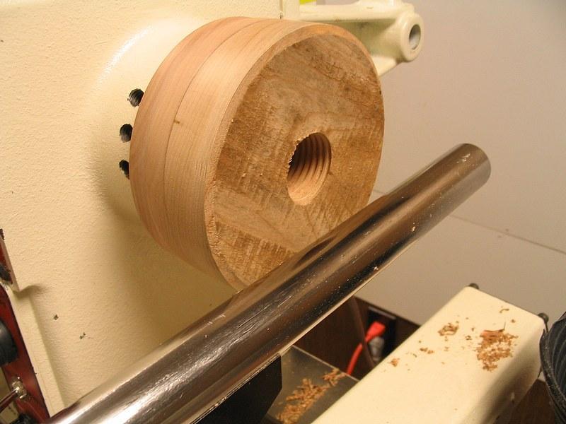 The spindle of the lathe is locked so that the blank cannot move. I use a crescent wrench to turn the tap a ½ turn and then snug up the tailstock center.