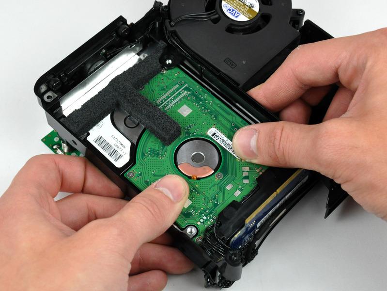 Step 18 Use your thumbs to slide the hard drive toward the speaker, disconnecting it from the