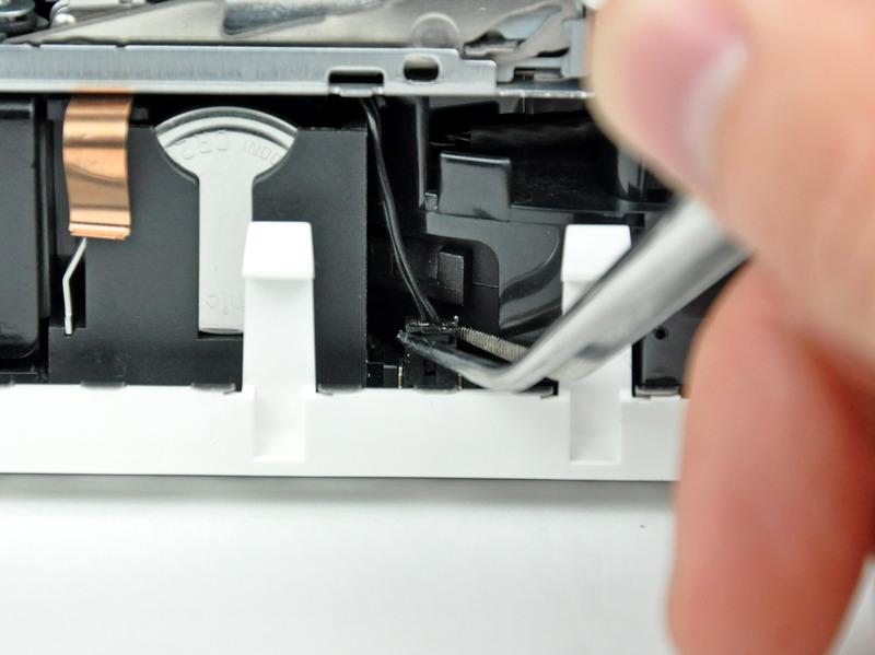 Step 10 Rotate the mini so that the SuperDrive slot loading mechanism is facing you.