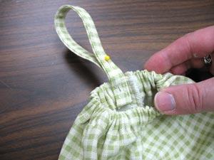 Add a loop to both the top and bottom of the organizer by positioning the ends of the loops next to the back seam.