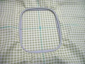 Hoop the fabric and stabilizer together by aligning the marks on the hoop with the