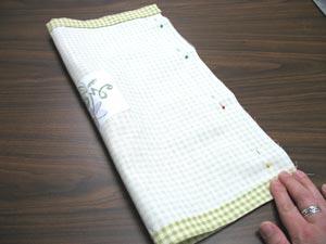 Next, fold the fabric right sides together with the left and right edges aligned. Pin in place.