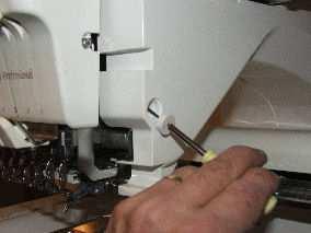 Turn off your machine. You will remove five (5) screws on the right side of the machine.