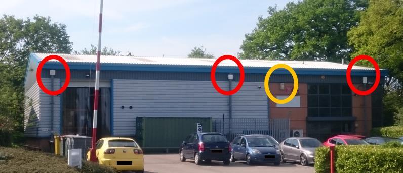 The roof line of the building is clearly visible in the radar image with surrounding cars and trees and the yellow dot shows the position