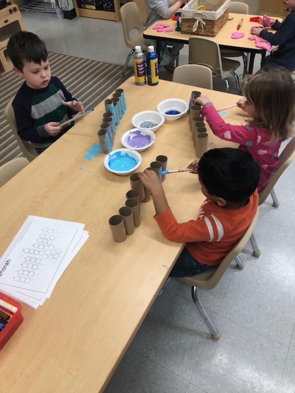 We had fun turning our sensory table into a farm table with farm animals, corn kernels and some small blocks. After we finished with our farm theme, we moved on to Hanukkah.