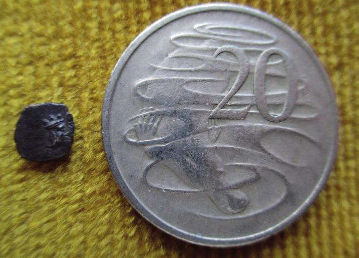 Figure 4 Another half-gerah (6 mms. 0.30 gram) next to an Australian 20-cents coin.