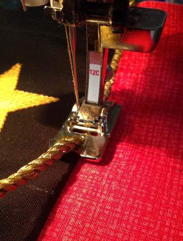 Press toward the red strip. Sew the yellow pieces to either side of the block using a ¼" seam allowance. Press toward the red strip.