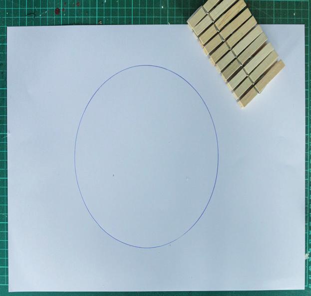 Lay the wooden clothes pegs out in a circle, leaving a gap of 3cm