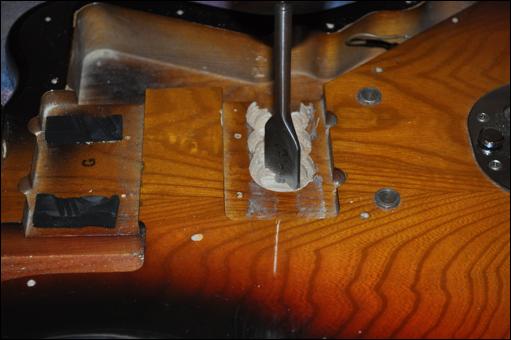 Step 4 Fit the guitar body to the new bridge pickup As we saw in the previous step, the new bridge pickup is sitting too high; I chose to remove some of the wood body beneath the pickup to allow it