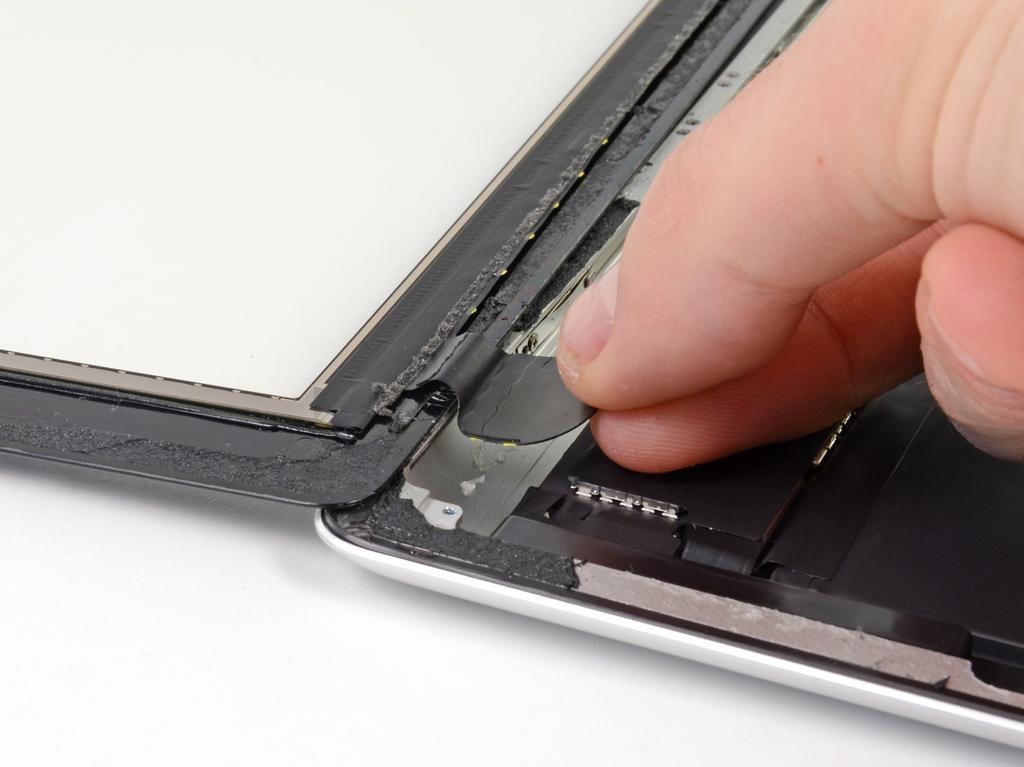 Step 36 Using your fingers, pull the touchscreen ribbon cable out of its recess in the aluminum frame. Remove the front panel from the ipad.